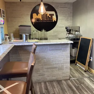 a view of a kitchen with a counter and chairs