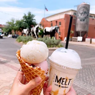 a person holding a cone of ice cream