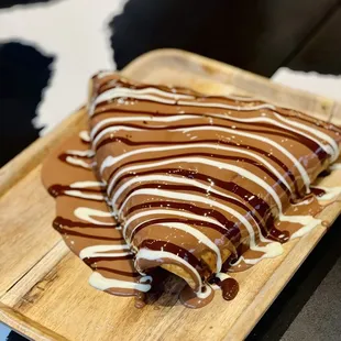 a wooden cutting board with a pastry on it