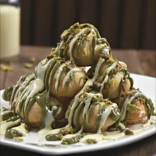 a pile of donuts with toppings