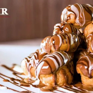 a pile of donuts covered in chocolate