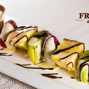 a fruit skewer on a white plate