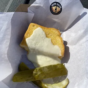 1/2 of the Melter Skelter sandwich and delicious pickles.
