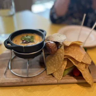 Queso Fuego - Cheddar and Emmenthaler cheeses, Big Storm Wavemaker Ale, fresh salsa, green onion, tortilla chips, jalapeño flambé