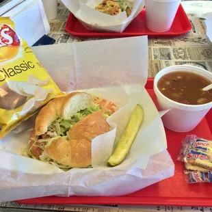 a sandwich and soup on a tray