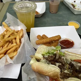 Passion fruit lemonade, philly steak, double order fries, and mozzarella sticks.