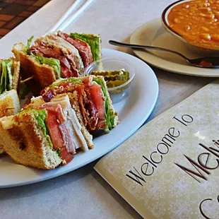 a plate of sandwiches and a bowl of soup
