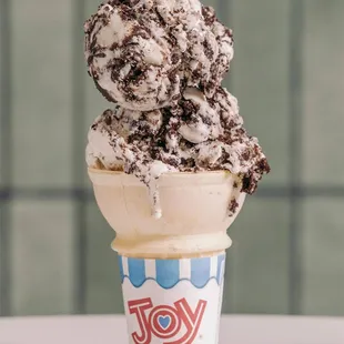 Homemade Cookies and Cream Ice Cream served in a wafer cone.