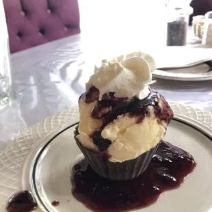 Dark Chocolate cup dessert with Vanilla ice cream and blackberry sauce.