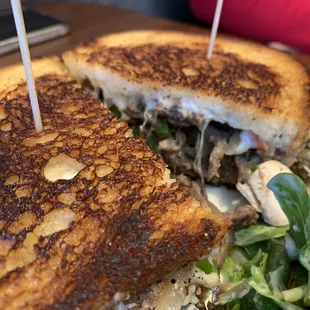 a grilled sandwich and salad