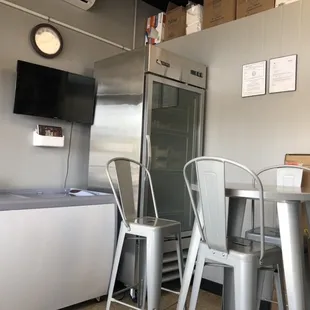 Kainan's NEW Dining Room and table with raised chairs next to the ice cream freezer and cooler.