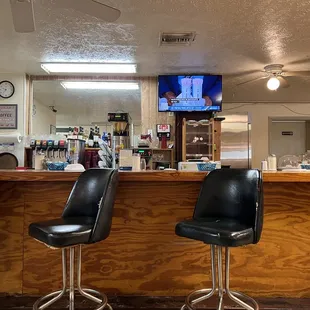 a bar with black chairs