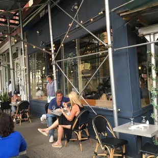 a group of people sitting outside a restaurant
