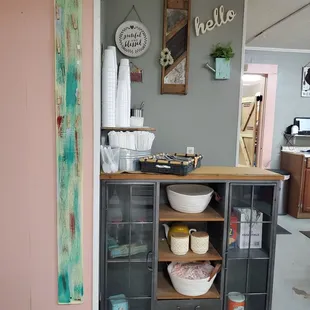 a kitchen area with a counter and shelves
