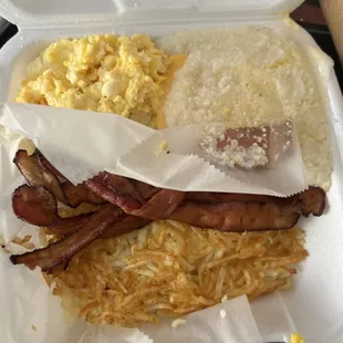 bacon, eggs, hash browns, and hash browns in a styrofoam container