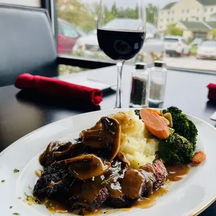  a plate of food and a glass of wine