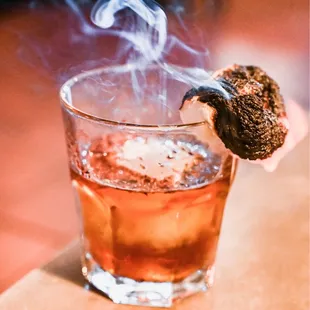 a drink with smoke coming out of it