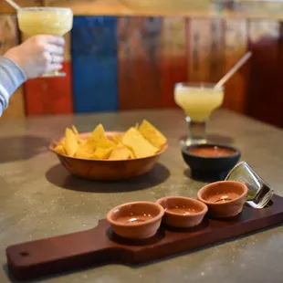 a woman holding a glass of margarita