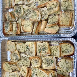 two pans of garlic bread