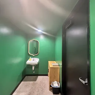 Liking this green wall gender neutral restroom
