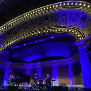 a stage with a piano and a piano player