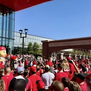 Nebraska players being welcomed through Tom Osborne Plaza.