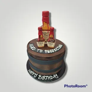 a birthday cake with a bottle of whiskey