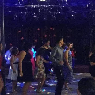 Full dance floor of teenagers line dancing.