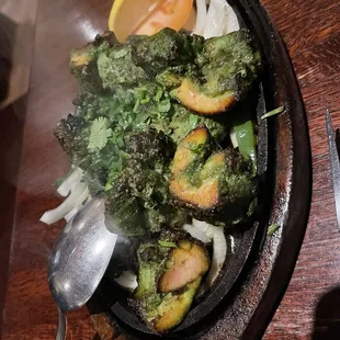 broccoli and onions in a cast iron skillet