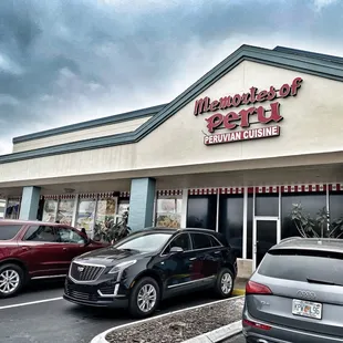 cars parked in front of a restaurant