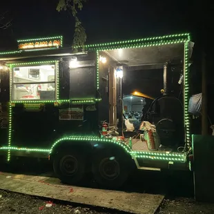 a food truck decorated with christmas lights
