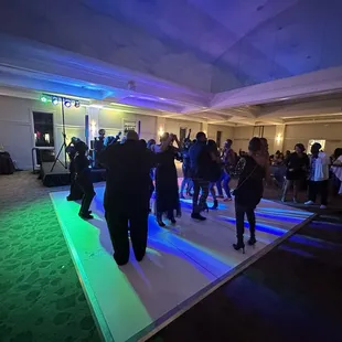a group of people dancing on a dance floor