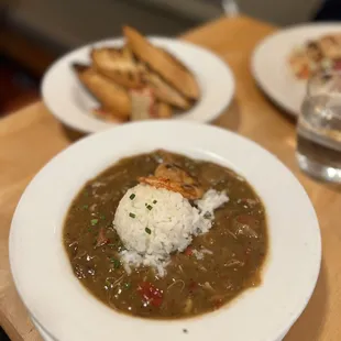 Bowl of gumbo with French roll