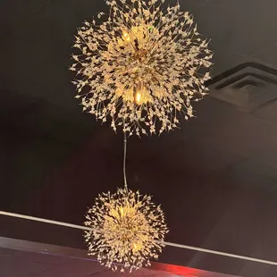 two chandeliers hanging from the ceiling