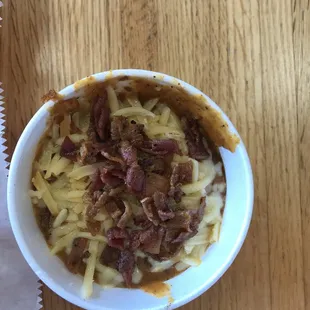 a bowl of food on a wooden table
