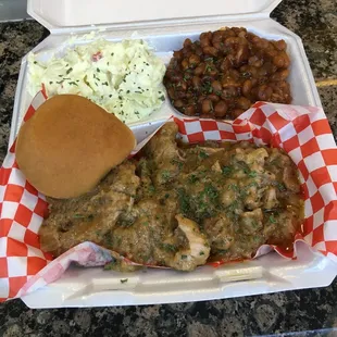 Smothered pork chops with potato salad baked beans