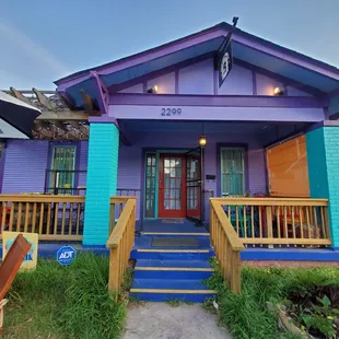 a purple house with blue trim
