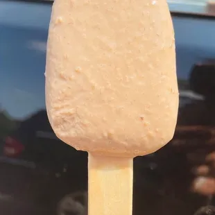 a hand holding a popsicle