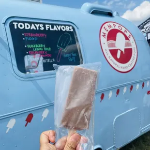 a hand holding a piece of ice cream