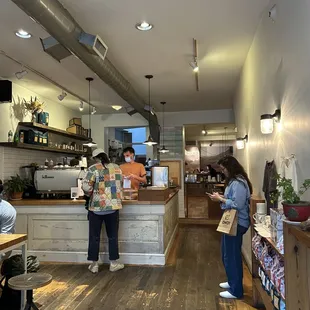 two people standing in a coffee shop