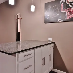&quot;Lunar Eclipse&quot; Quartz counters and custom cabinets with glass fronts and built-in wine bottle shelf.