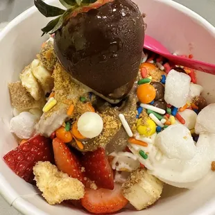 a bowl of ice cream and strawberries