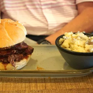 Brisket sandwich with side of mashed potatoes