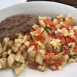 a plate of food with beans, potatoes, and beans