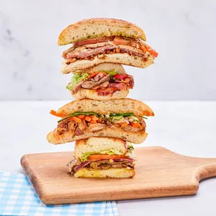 a stack of sandwiches on a cutting board