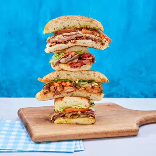 a stack of sandwiches on a cutting board