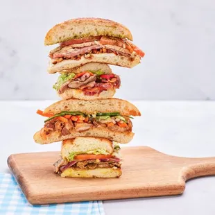 a stack of sandwiches on a cutting board
