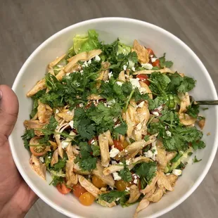 a person holding a bowl of food