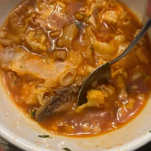 a person holding a spoon in a bowl