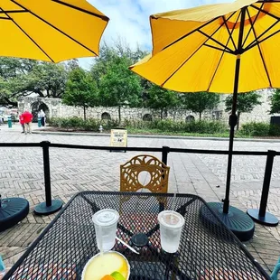 a table with two yellow umbrellas
